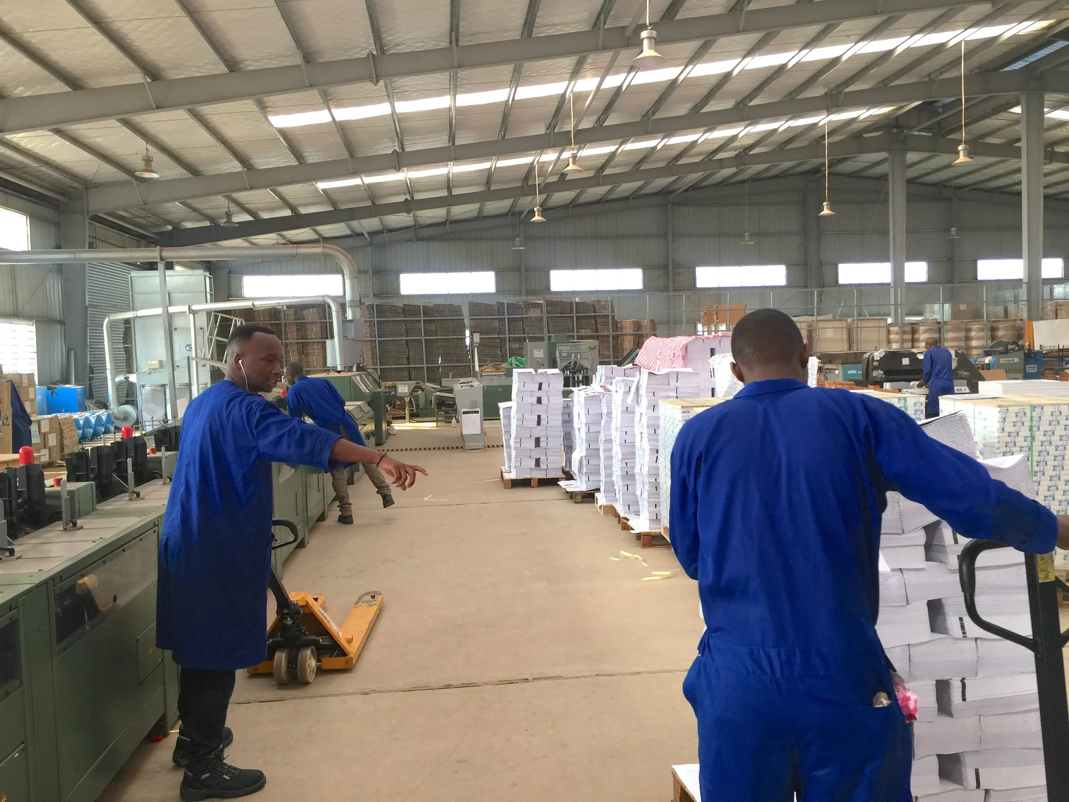 Workers inside an industrial production facility
