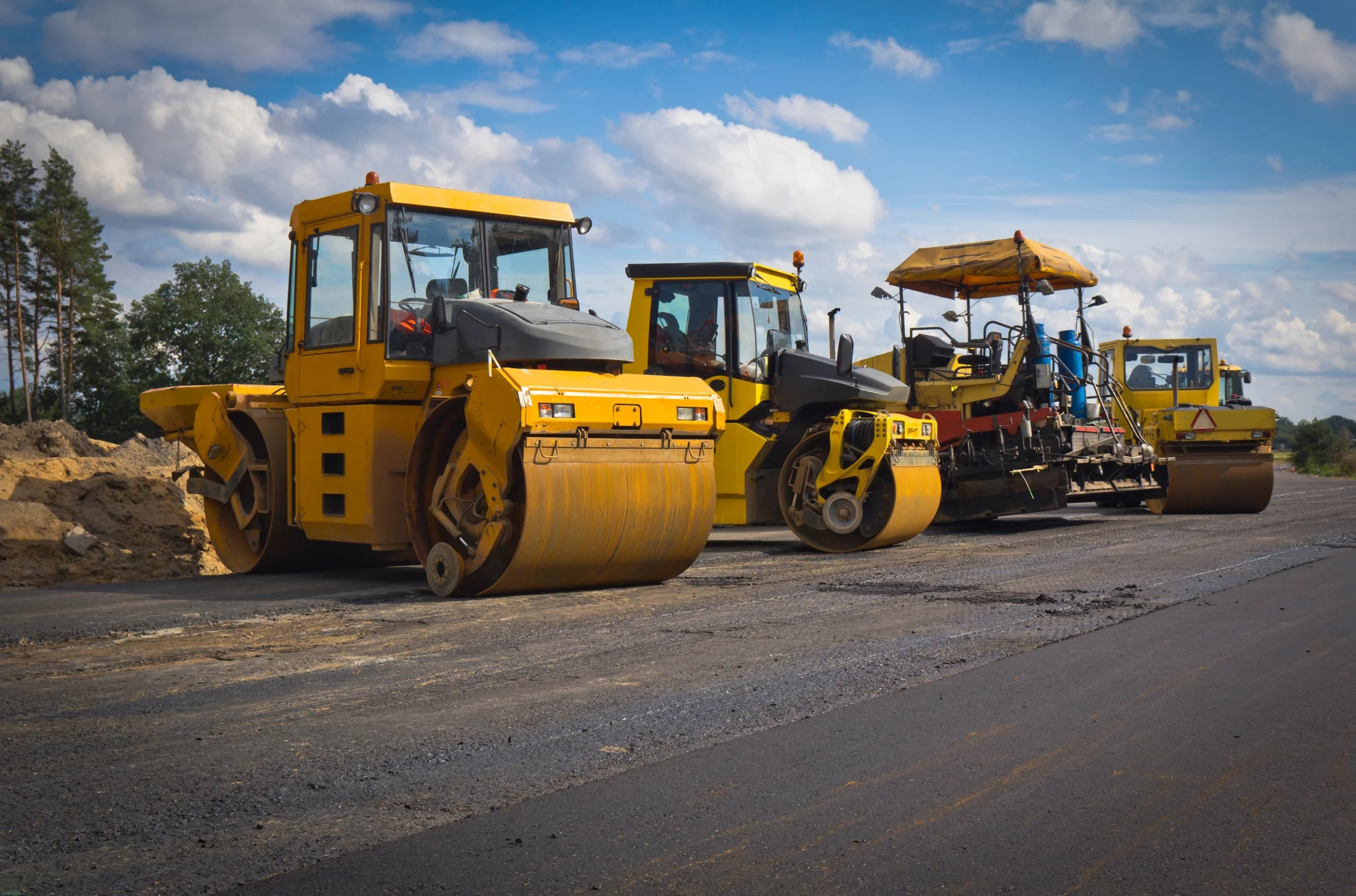 Yellow road rollers and construction machinery